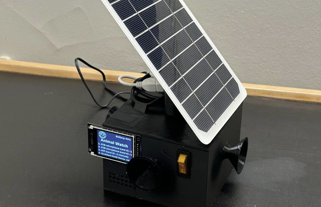 Black enclosure with a small solar panel mounted on top