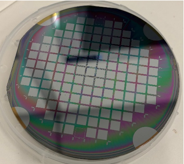 Silicon wafer with a grid pattern showing iridescent thin-film colors